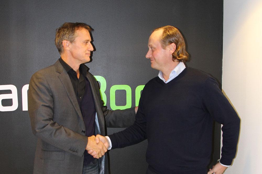 Michael Pask, Senior Vice President of IMG (left) and Mikko Manerus, CEO of GameBook shook hands to seal the partnership.